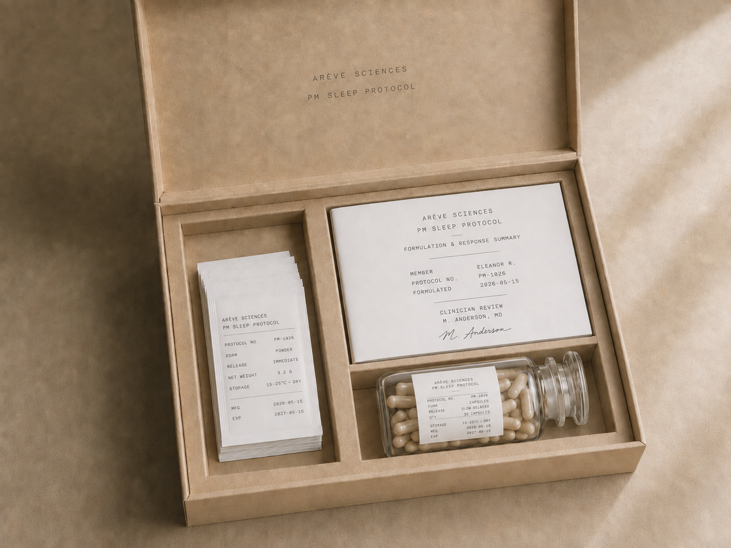 An open Arève Sciences PM Sleep Protocol box containing personalised sachets, a glass capsule jar, and a clinician-signed formulation card